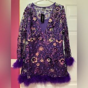 Sequined purple dress with feathery cuffs & hem.